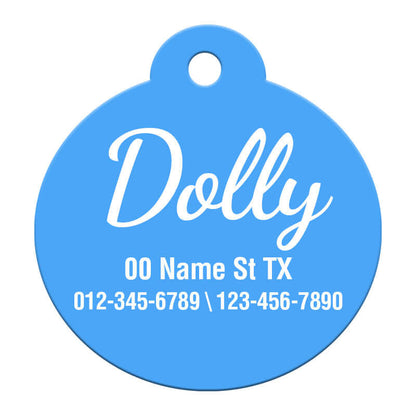 Vibrant blue round pet ID tag labeled 'Dolly' with full address and dual contact numbers, ensuring comprehensive pet safety