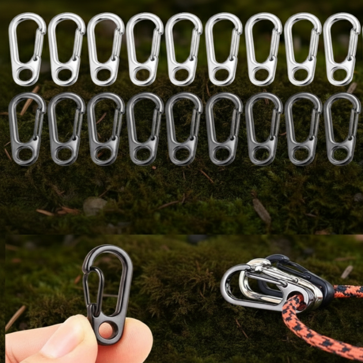 Set of metal carabiners on a grassy background